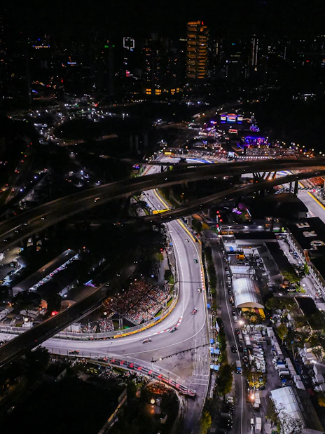 Aerial view of the illuminated Formula 1 Singapore Grand Prix circuit at night.