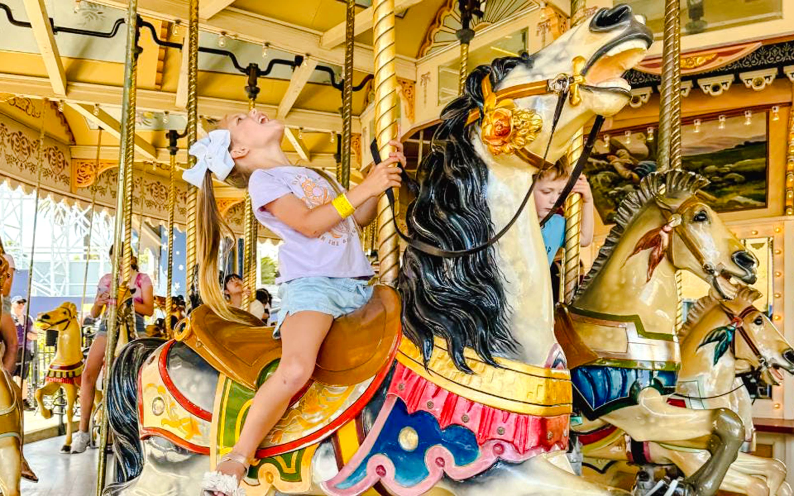 Child enjoying carousel ride at Luna Park Melbourne.