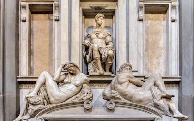Medici Chapel sculptures in Florence, featuring reclining figures and seated statue.