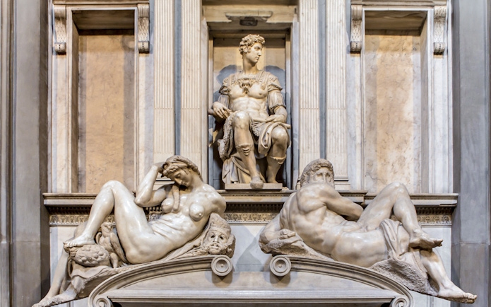 Medici Chapel sculptures in Florence, featuring reclining figures and seated statue.