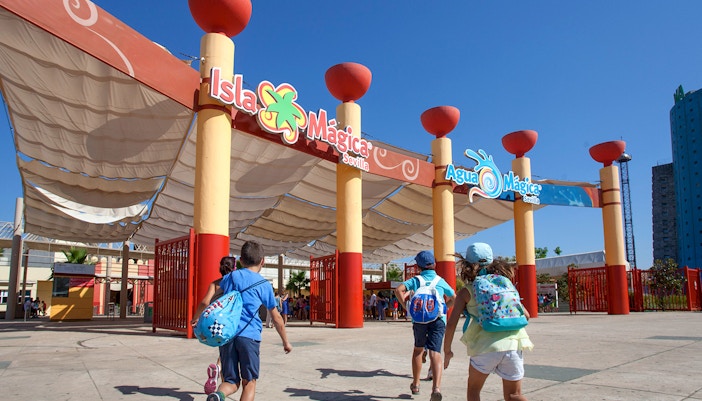 Tourists on a roller coaster at Isla Mágica amusement park, Seville, Spain.