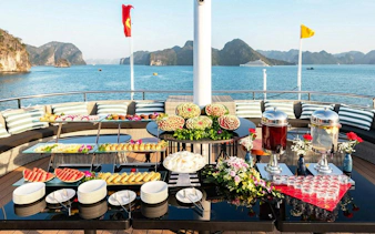 Buffet setup on La Casta Day Cruise deck with Ha Long Bay view.