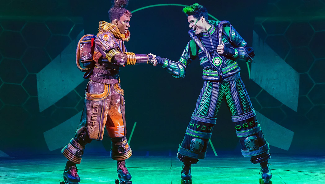 Performers in futuristic costumes on roller skates in Starlight Express show.
