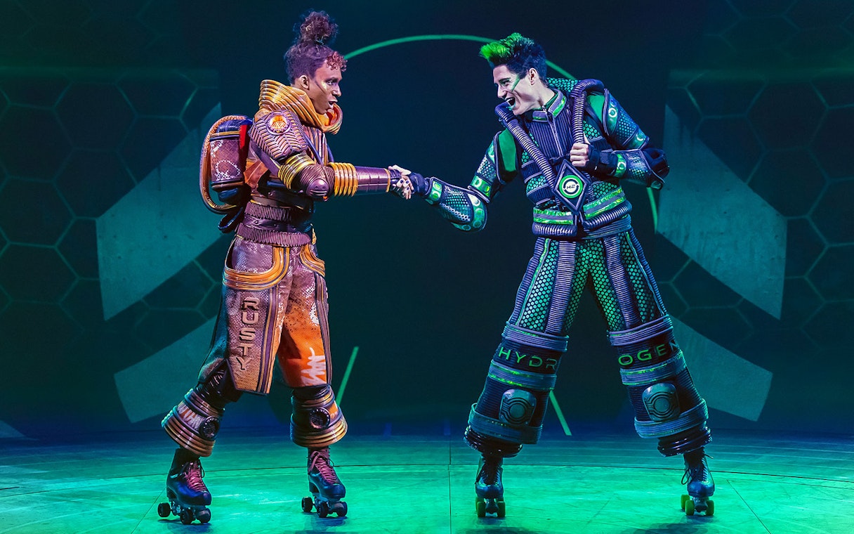 Performers in futuristic costumes on roller skates in Starlight Express show.