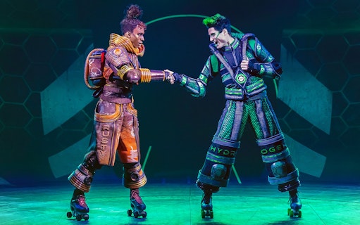 Performers in futuristic costumes on roller skates in Starlight Express show.