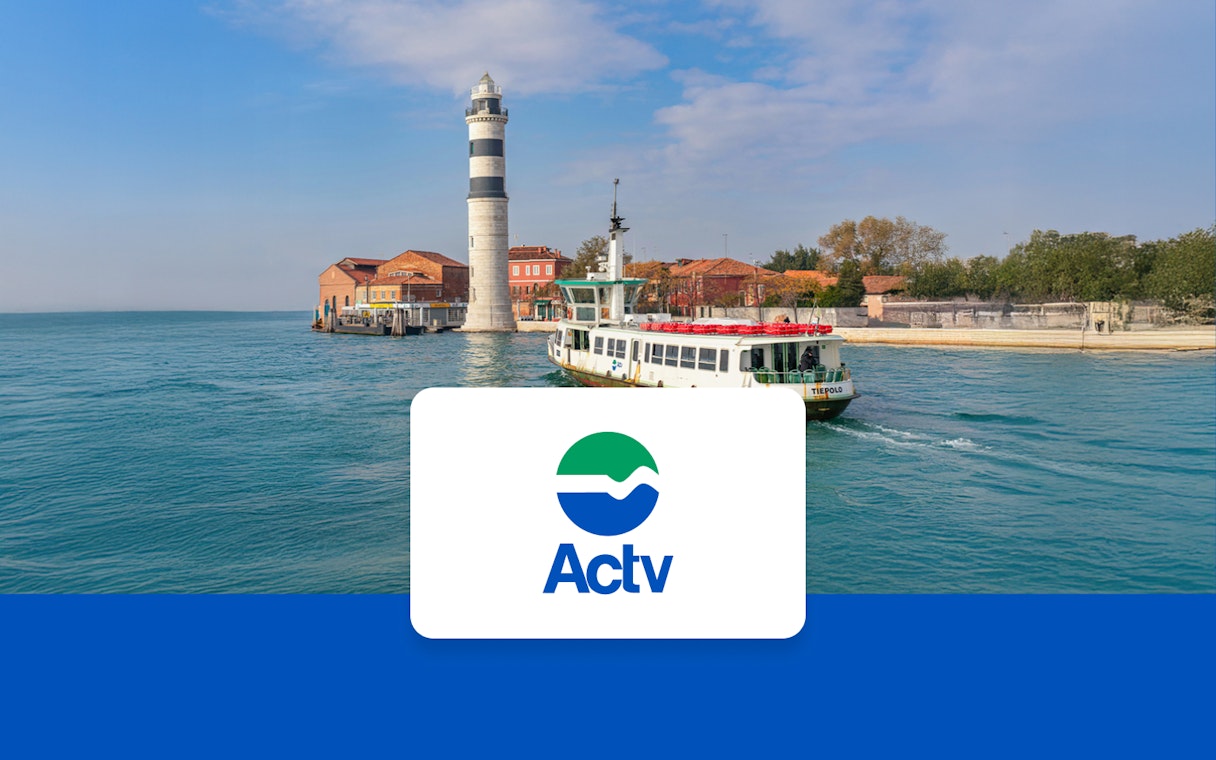 ACTV ferry approaching Murano and Burano with a lighthouse in the background.