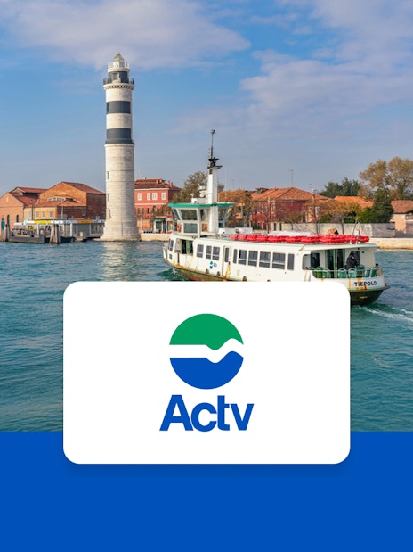ACTV ferry approaching Murano and Burano with a lighthouse in the background.