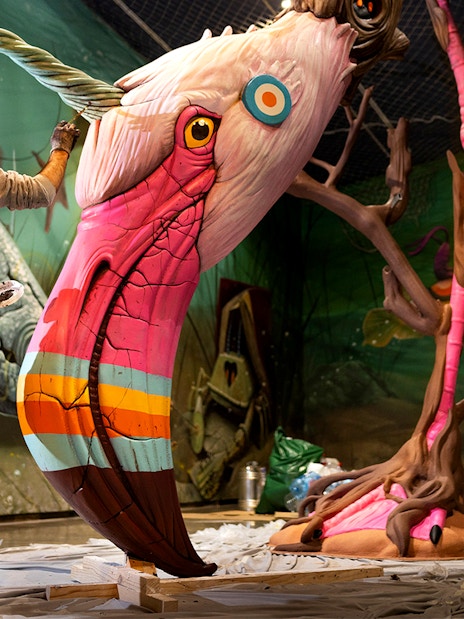 Artist painting colorful sculpture at STRAAT Museum in Amsterdam.