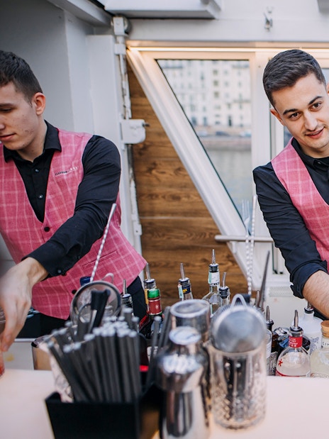 Bartender preparing cocktails on New Year's Eve dinner cruise.