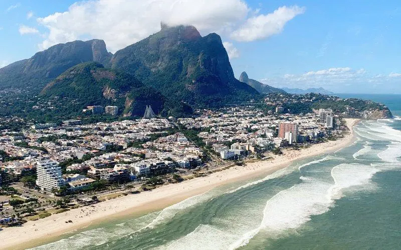 Aerial view of Barra da Tijuca coastline and Pedra da Gávea during Rio de Janeiro helicopter tour.