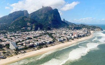 Aerial view of Barra da Tijuca coastline and Pedra da Gávea during Rio de Janeiro helicopter tour.