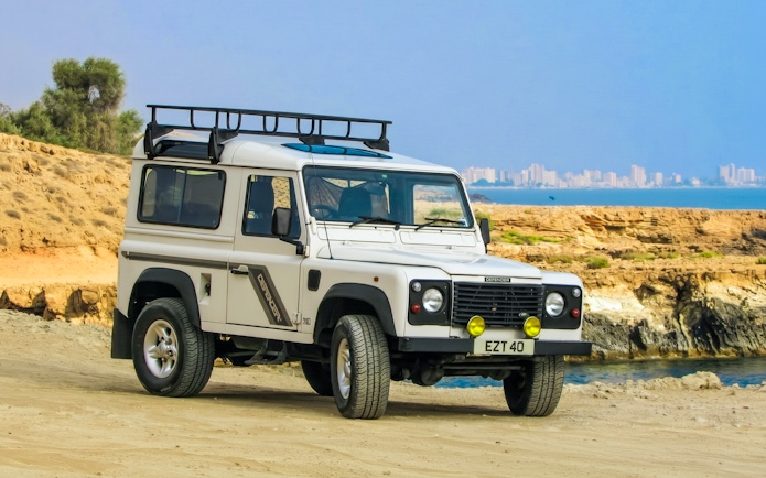 Jeep on a safari tour in the Troodos Mountains, Cyprus, with coastal view.