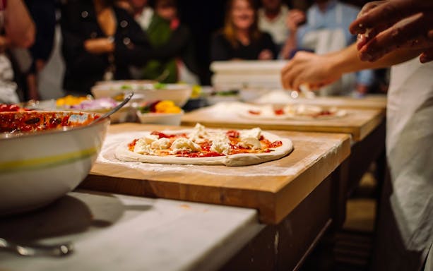 Pizza preparation during a cooking class at a Tuscany farmhouse near Florence.
