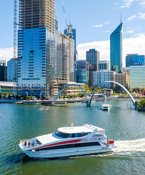 Ferry boat on Swan River with Perth city skyline in background.
