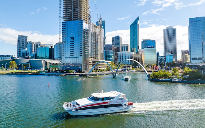 Ferry boat on Swan River with Perth city skyline in background.