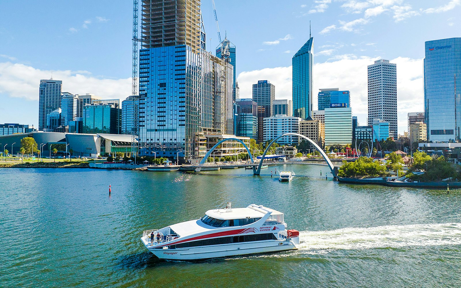 Ferry boat on Swan River with Perth city skyline in background.