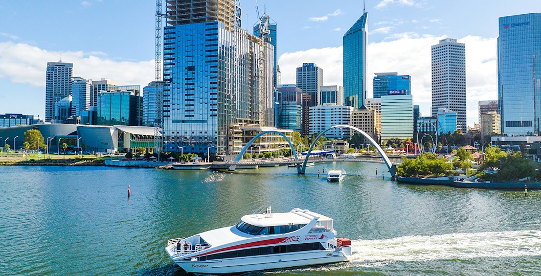 Ferry boat on Swan River with Perth city skyline in background.