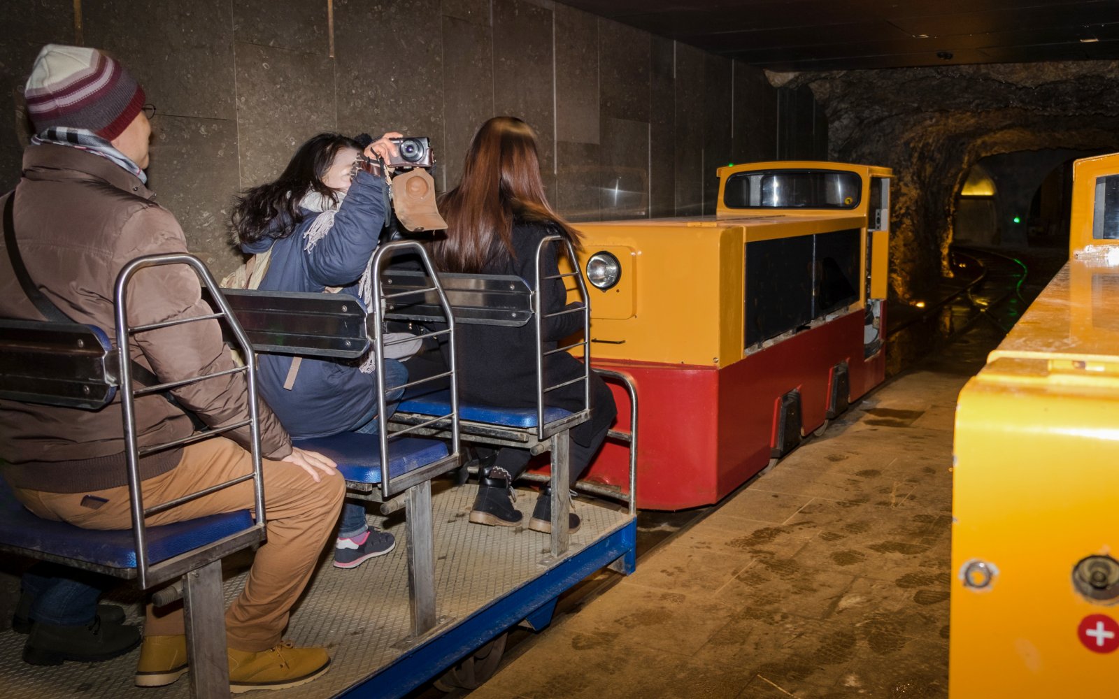 Tourists on a train inside Postojna Cave during an excursion.