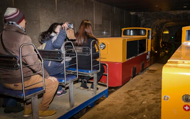 Tourists on a train inside Postojna Cave during an excursion.