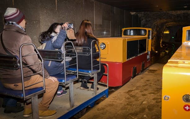 Tourists on a train inside Postojna Cave during an excursion.