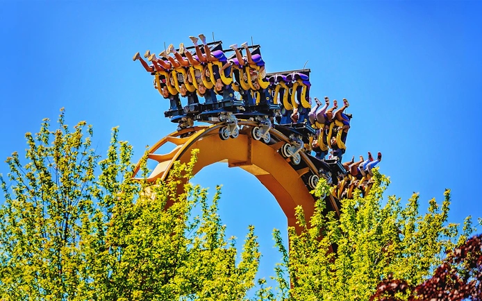 Riders upside down on BATMAN™ The Ride roller coaster at Six Flags Great America.