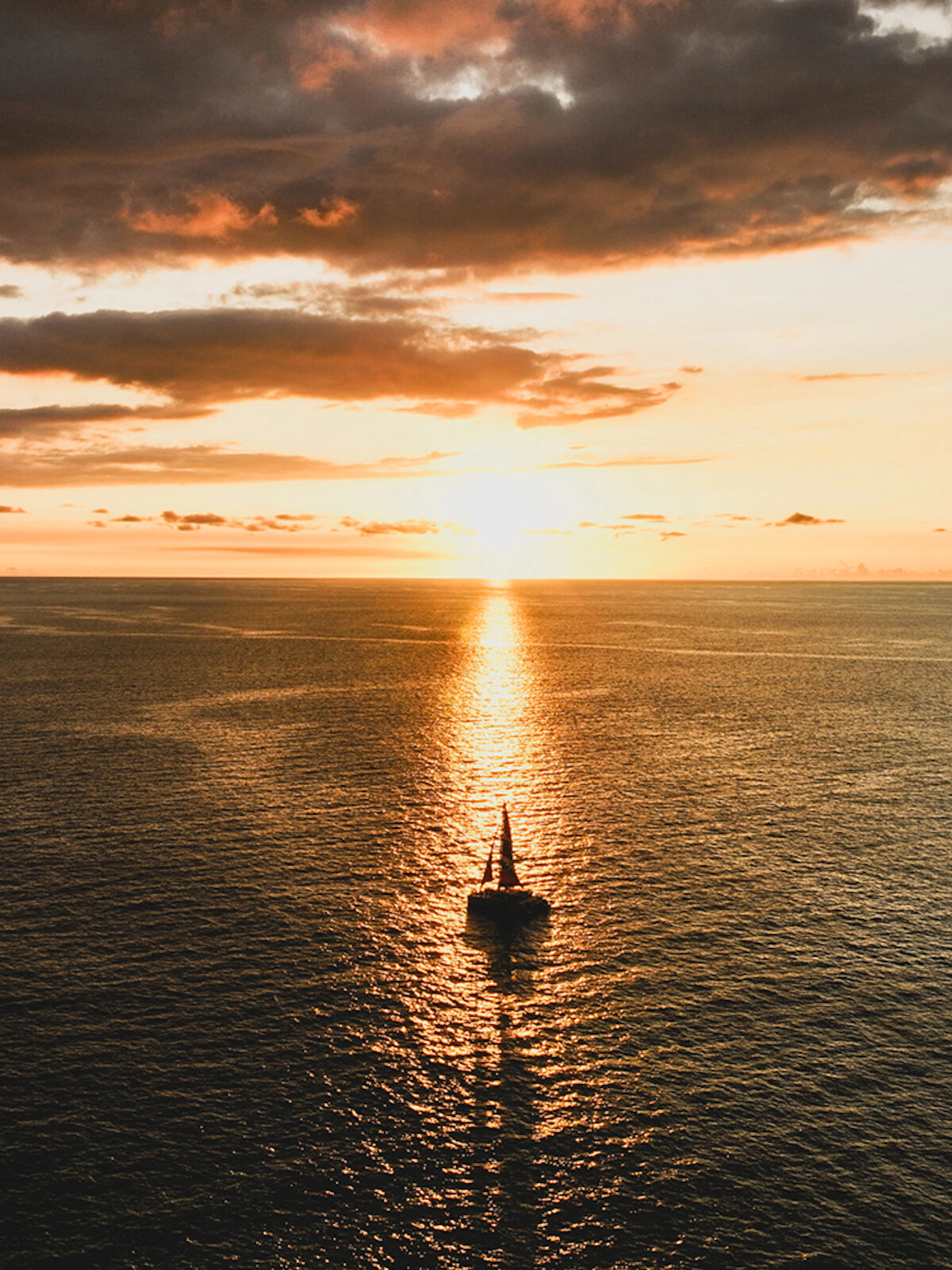 Sailboat on Waikiki waters during sunset sail.