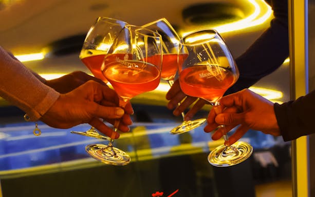 Toasting with Prosecco glasses on a 90-minute sightseeing cruise.