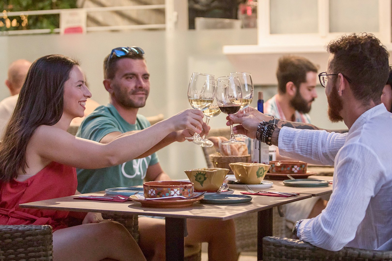 Group toasting with wine at Alegría Flamenco & Gastronomia dining experience.