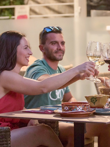 Group toasting with wine at Alegría Flamenco & Gastronomia dining experience.