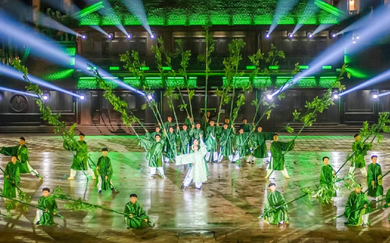 Performers in traditional attire with bamboo props at The Quintessence of Vietnam Show.