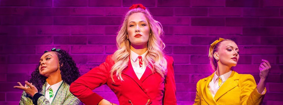 Performers in colorful costumes on stage in Heathers the Musical, West End.