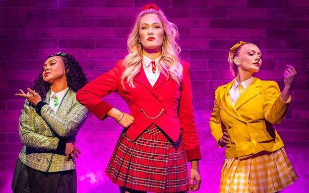 Performers in colorful costumes on stage in Heathers the Musical, West End.