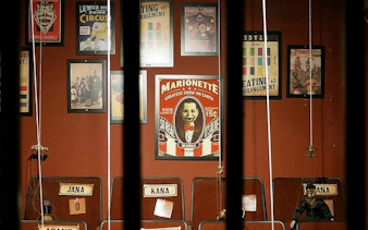 Marionette posters and strings in Breakout Avenue K's Chamber of Hocus, Dubai escape room.