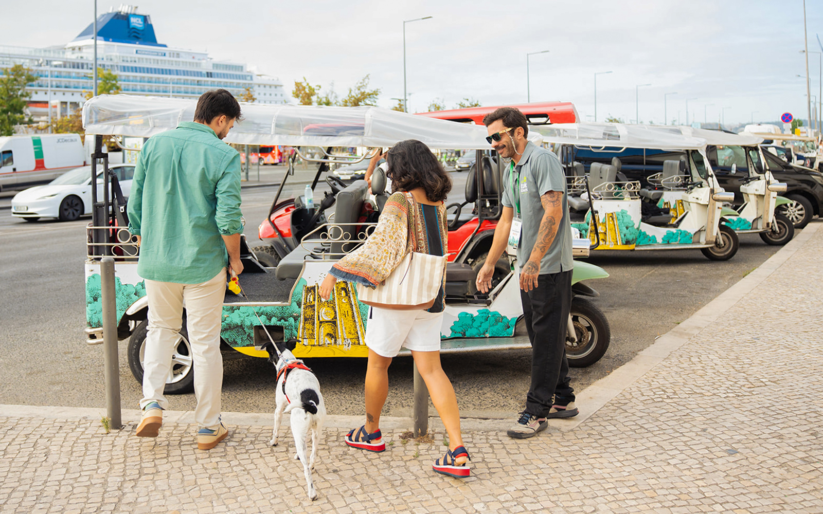 Tourist boarding eco tuk-tuk with pet in Lisbon.