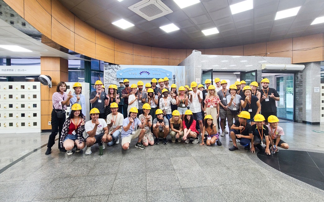 Tour group wearing helmets at the entrance of the Third Infiltration Tunnel, DMZ, South Korea.