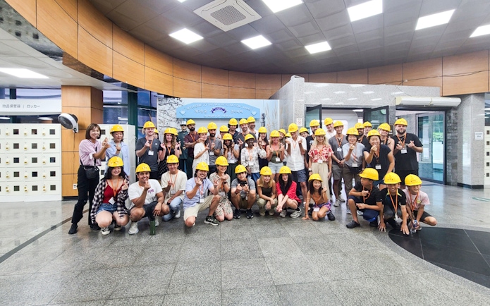 Tour group wearing helmets at the entrance of the Third Infiltration Tunnel, DMZ, South Korea.