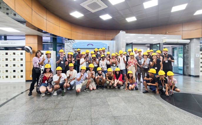 Group of tourists wearing yellow helmets at the Korean Demilitarized Zone tour.