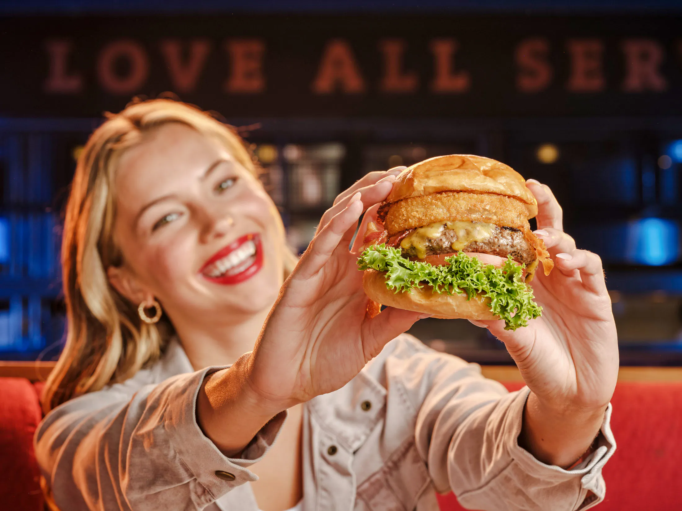 Burger with onion rings and lettuce at Hard Rock Cafe, Amsterdam.