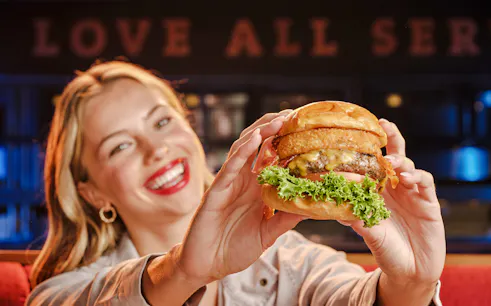 Burger with onion rings and lettuce at Hard Rock Cafe, Amsterdam.