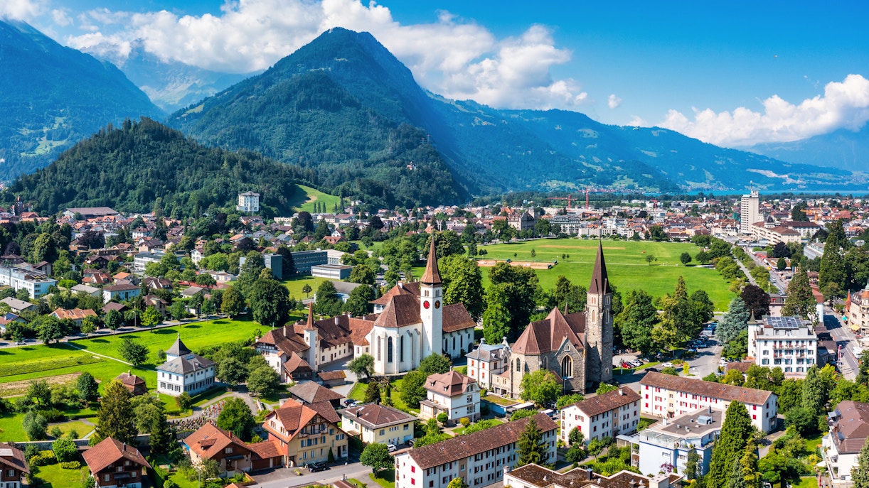 Aerial view of Interlaken, Switzerland, with churches and mountains in the background.