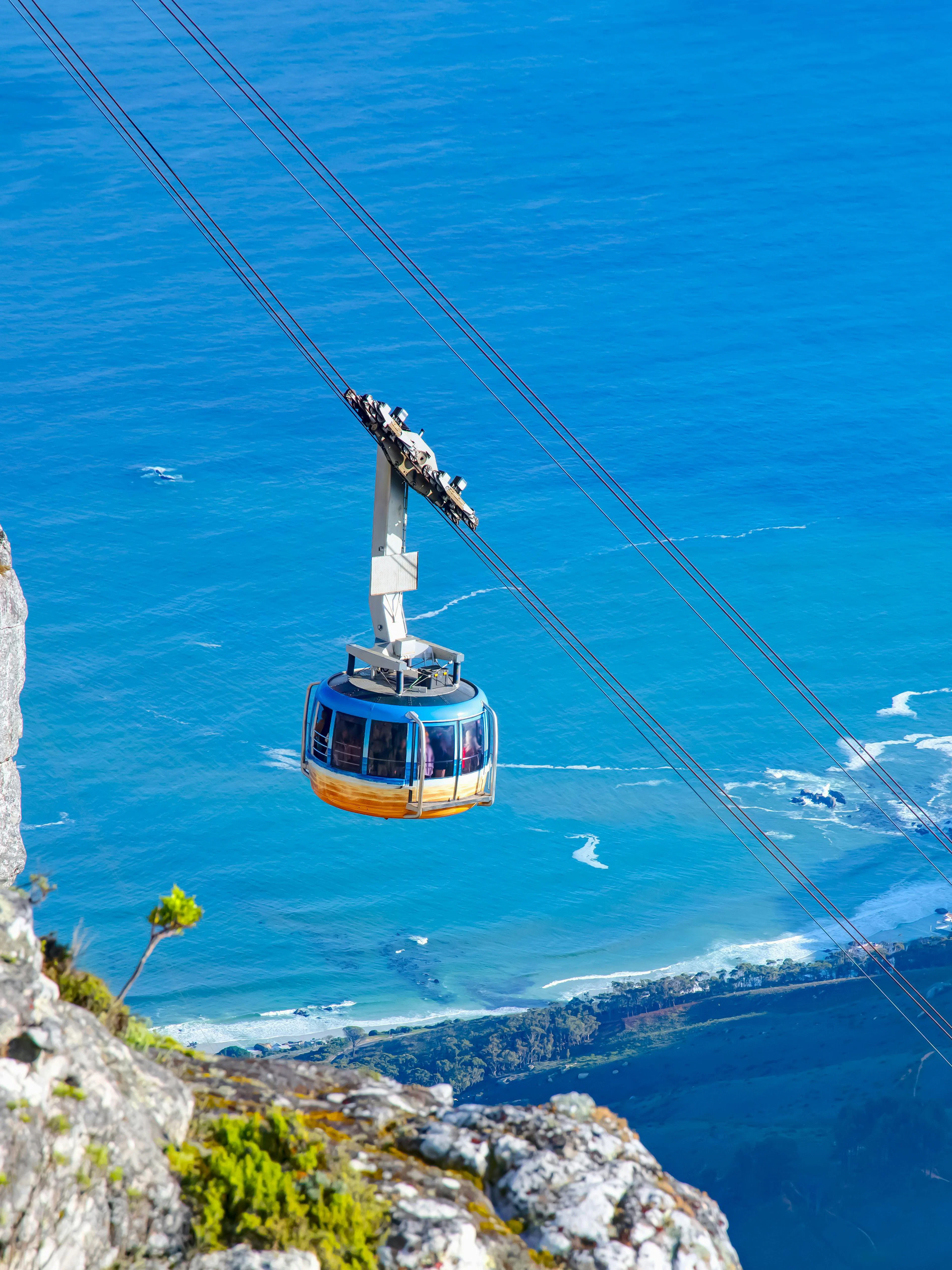 Cable car ascending Table Mountain with ocean view, Cape Town, South Africa.