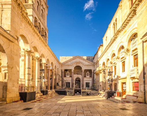 Peristyle square in Diocletian's Palace, Split, Croatia, featuring ancient columns and arches.