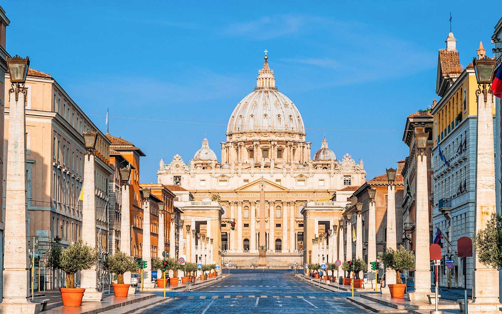 Vatican Grottoes with visitors exploring historic tombs beneath St. Peter's Basilica, Vatican City.