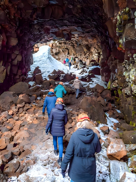 Guests exploring Raufarhólshellir Lava Cave in Iceland.
