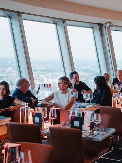 Dining at Berlin TV Tower with city view.
