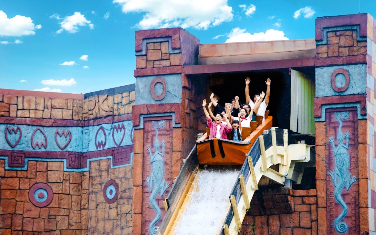 Visitors enjoying the Dino Island log flume ride at LEGOLAND Malaysia Resort.