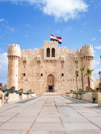 Entrance of Citadel of Qaitbay in Alexandria, Egypt, with Egyptian flag above.