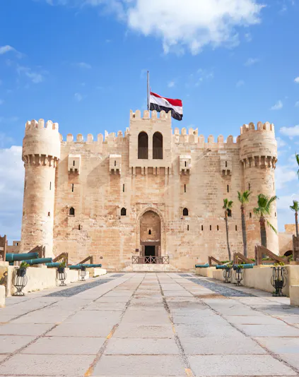 Entrance of Citadel of Qaitbay in Alexandria, Egypt, with Egyptian flag above.