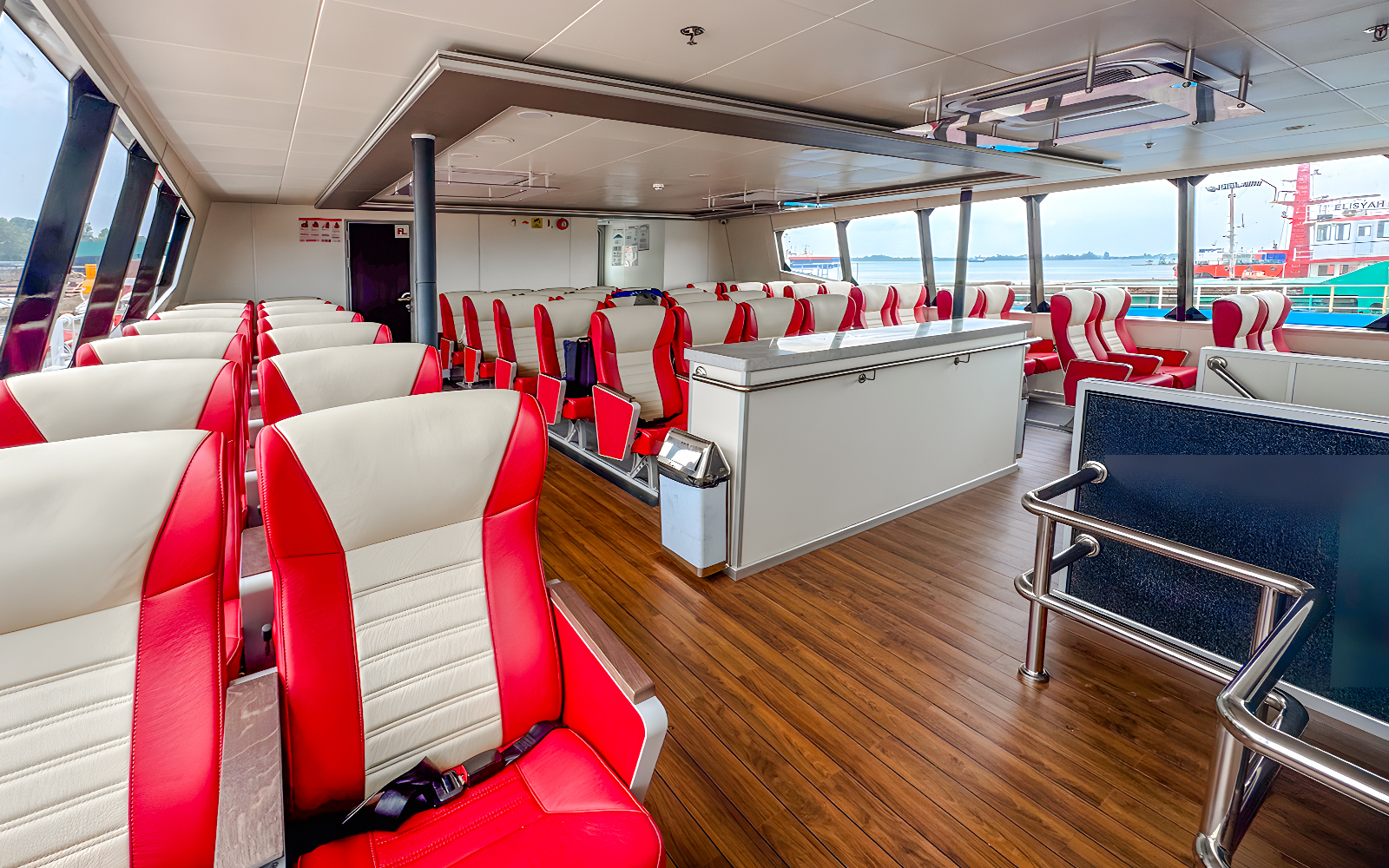 Ferry interior with red and white seats on the Singapore to Batam route.