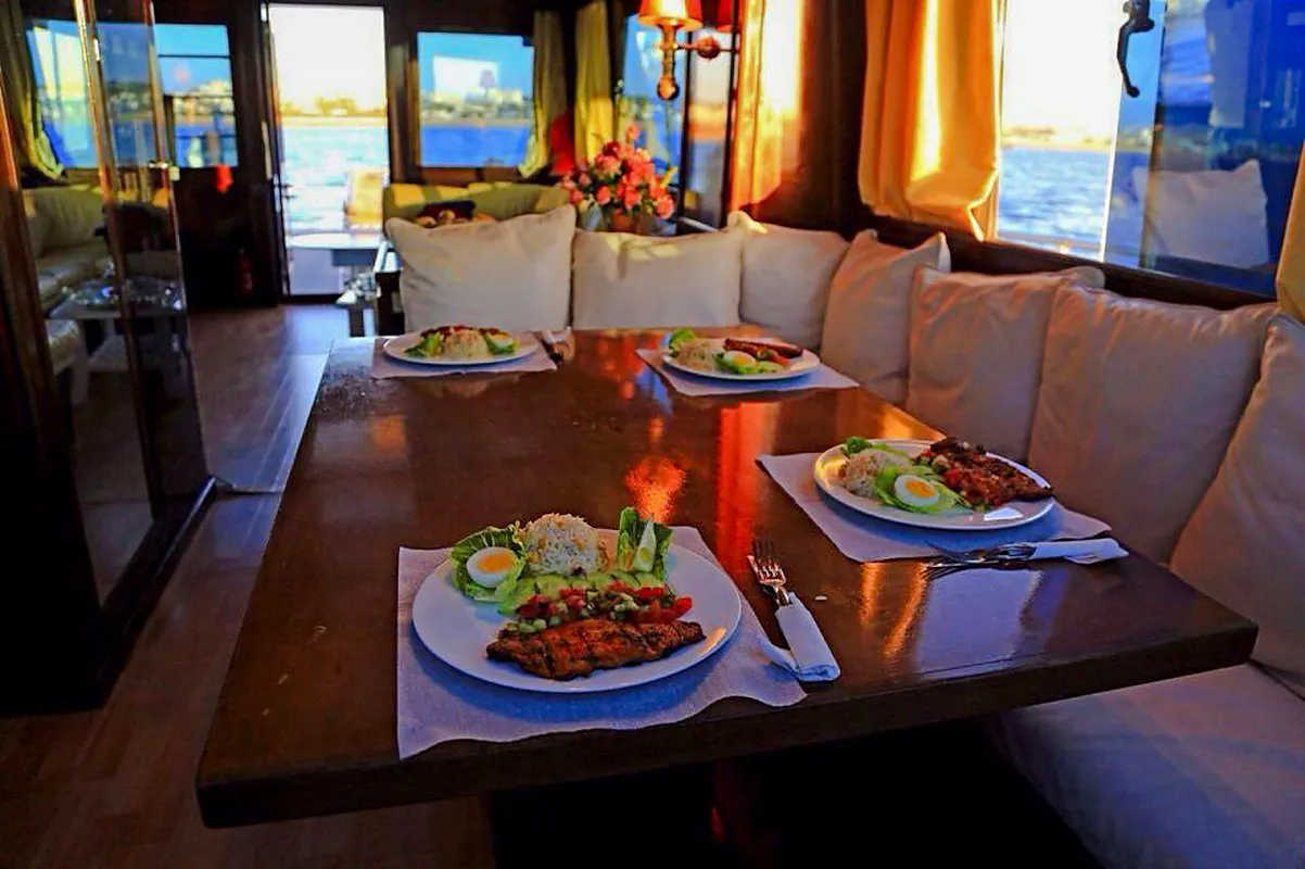Dining setup on a boat with meals served, part of the Half Day Boat Trip from Agadir.